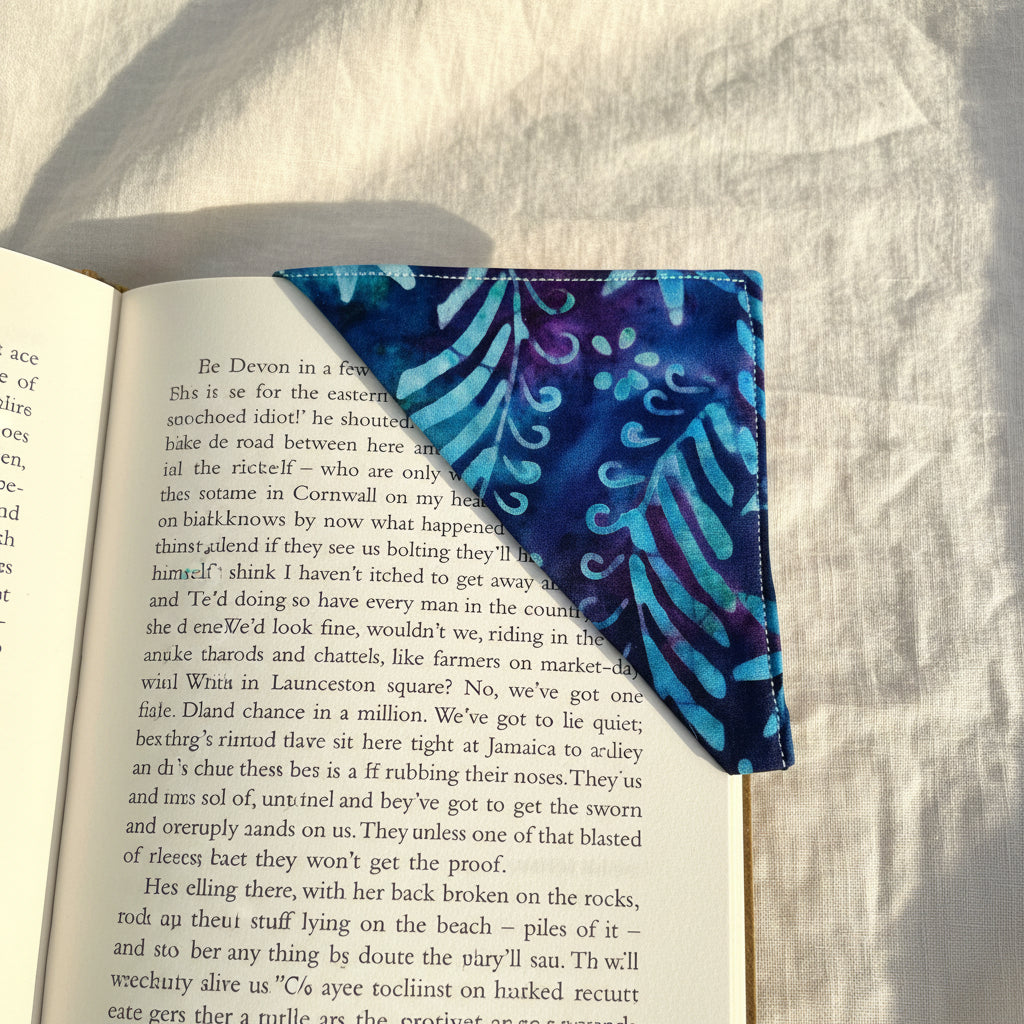 Blue fabric with a pattern on top corner of a book page