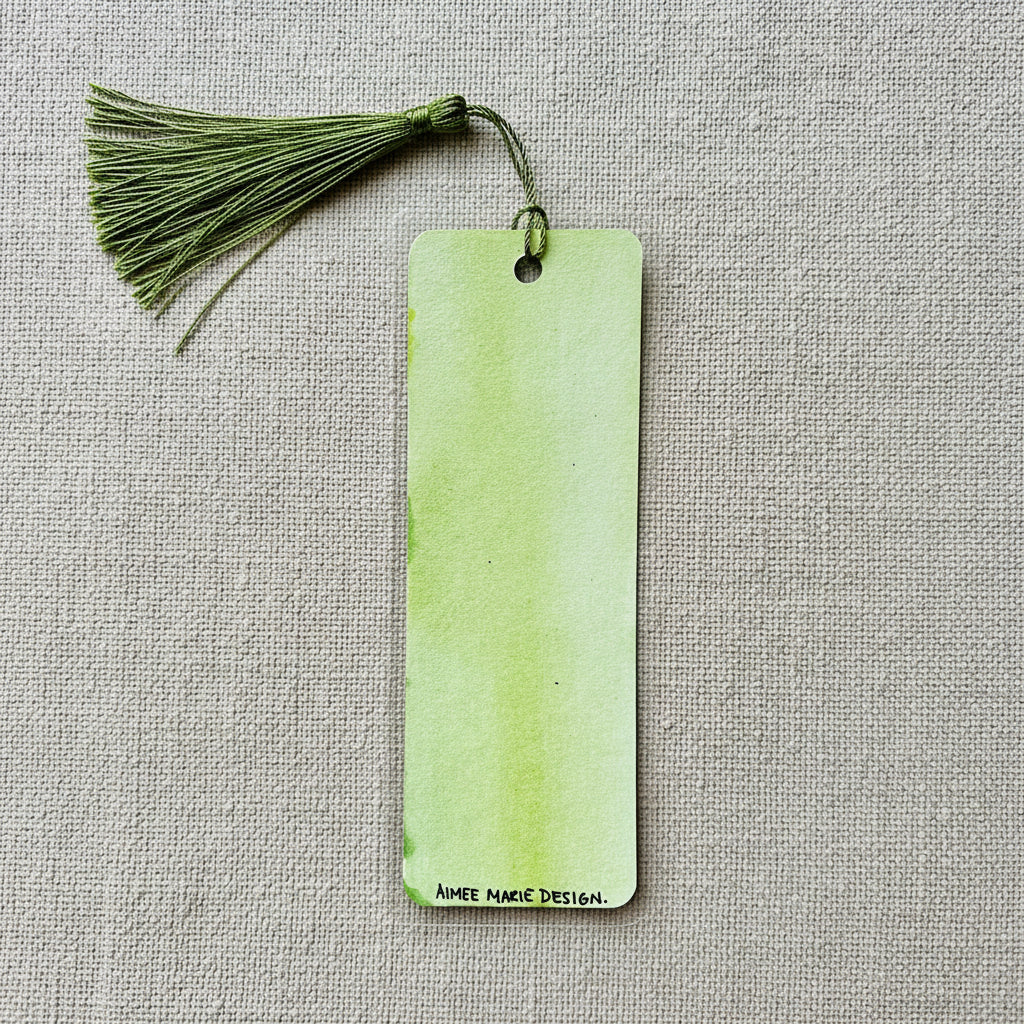 Green bookmark with tassel and 'Aimee Marie Design' logo on a light gray background.