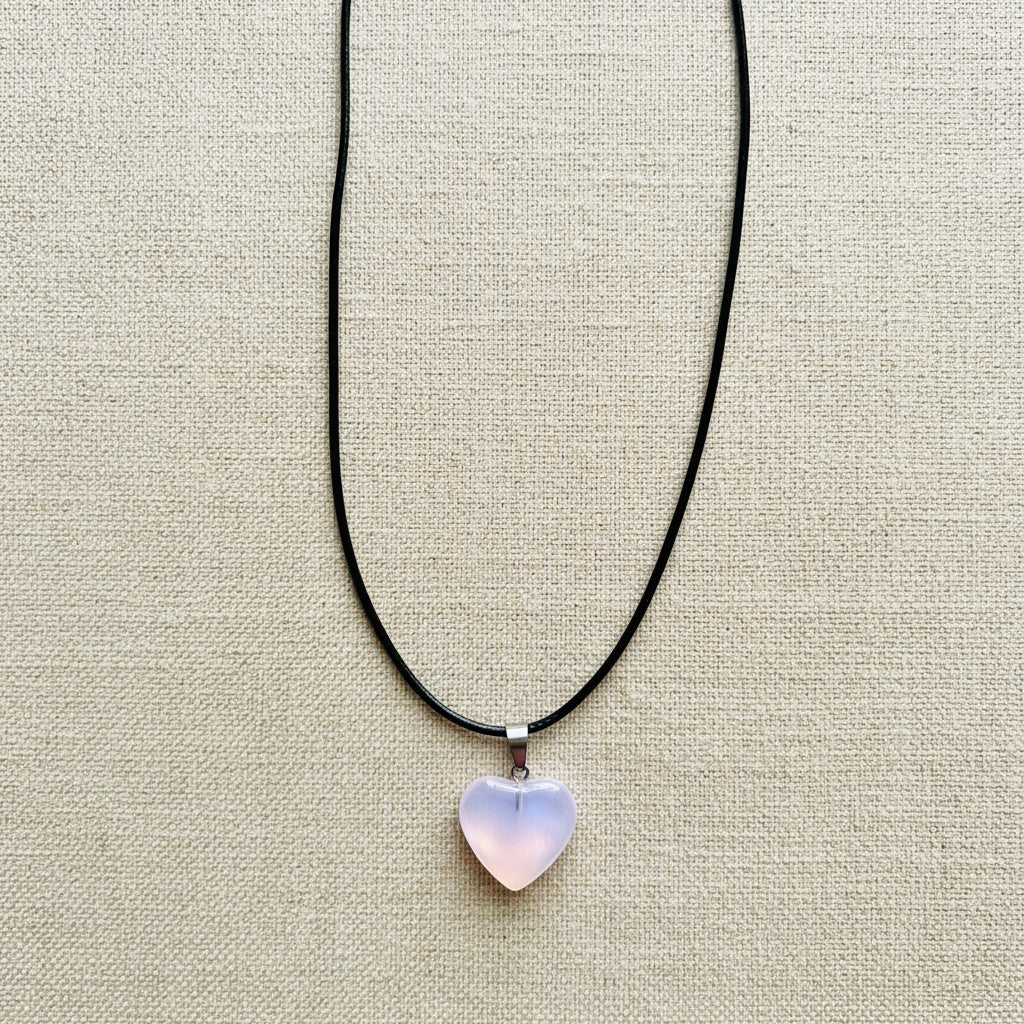 Necklace with a heart-shaped pendant on a light neutral background