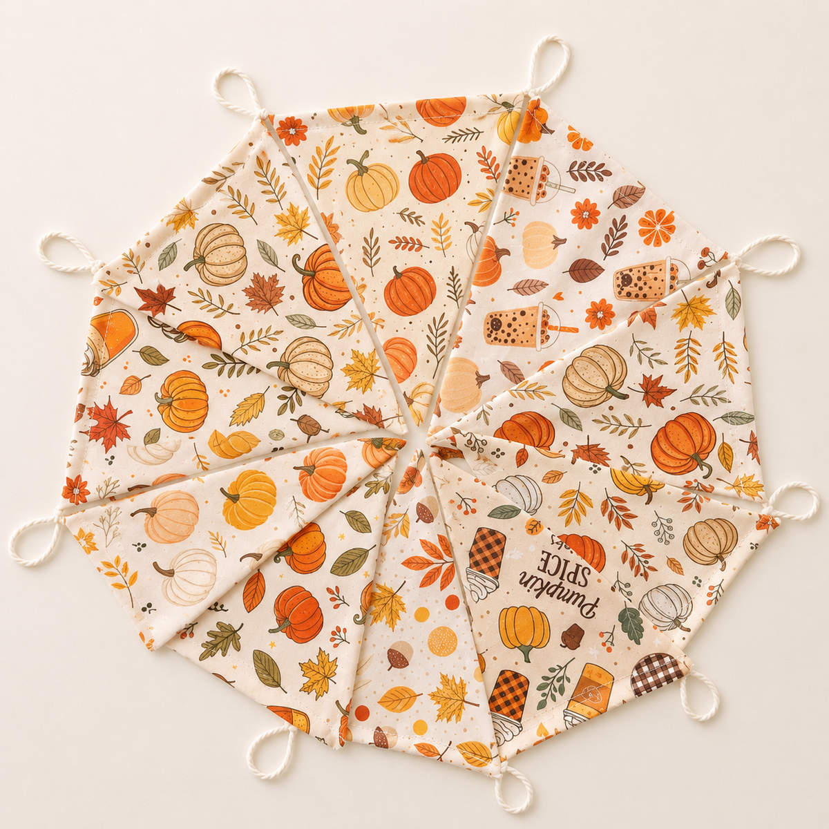 Handmade autumn fabric bunting with 10 moveable flags featuring pumpkins, leaves and cosy seasonal designs in warm autumn colours.