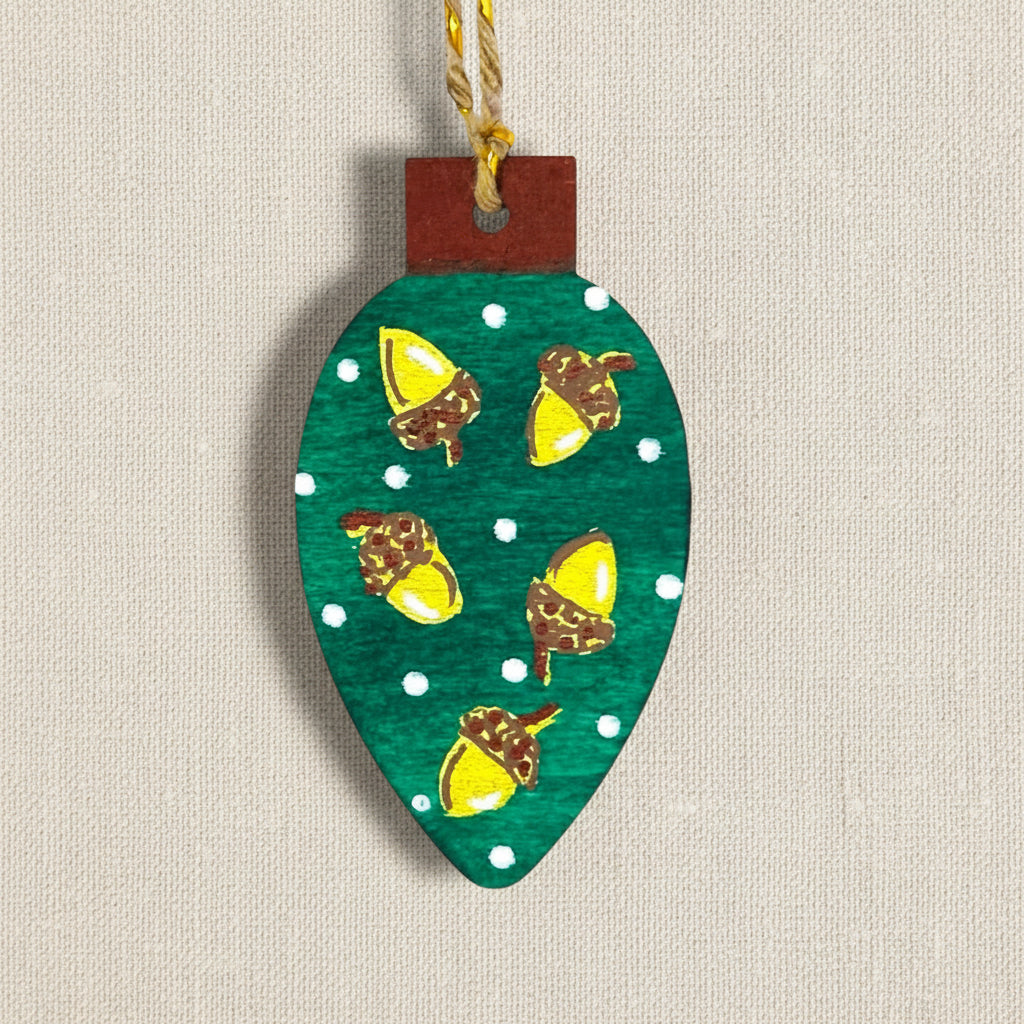 Decorative wooden ornament shaped like a Christmas tree light with hand painted acorn design