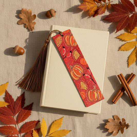Wooden Bookmark with pumpkin design and tassel placed on a book