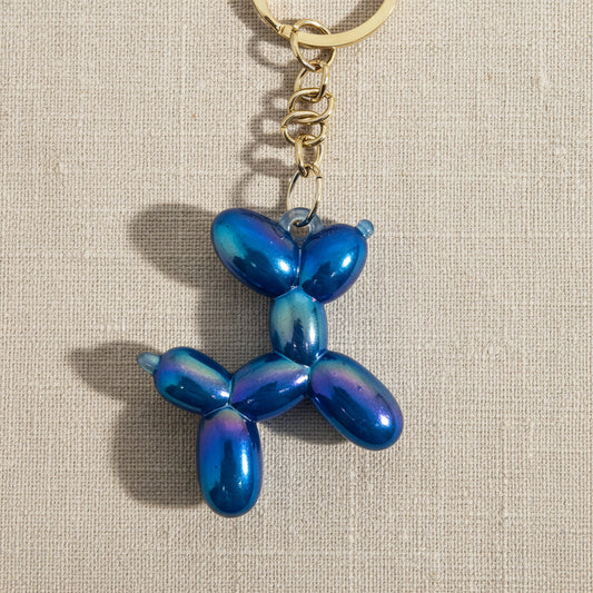 Blue balloon dog keychain on a light background