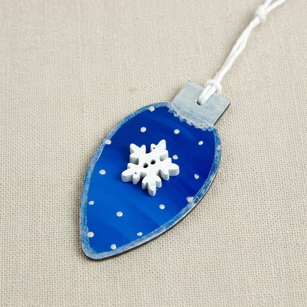 Blue Christmas light bulb shaped wooden ornament with a wooden snowflake embellishment 