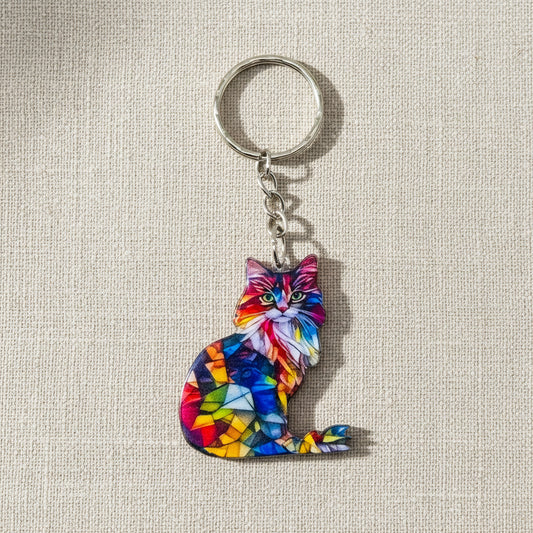 Colourful cat-shaped keychain on a neutral background