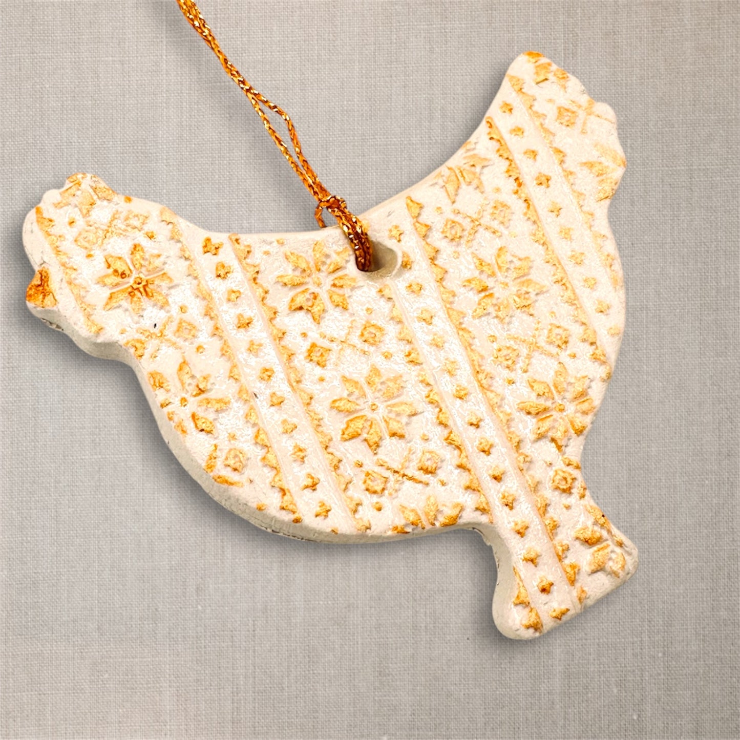 Decorative ceramic chicken hanging ornament with textured surface on a neutral background