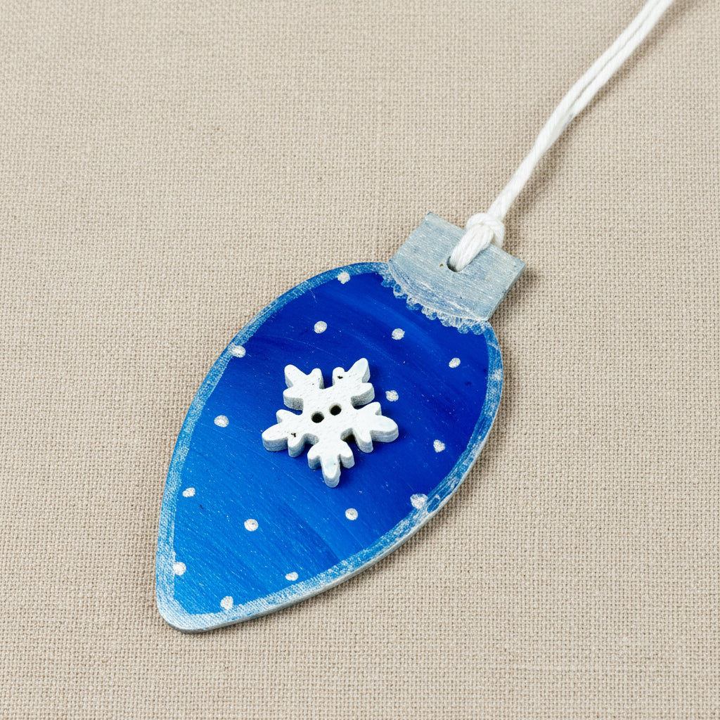 Blue and silver wooden tree ornament with white snowflake embellishment 