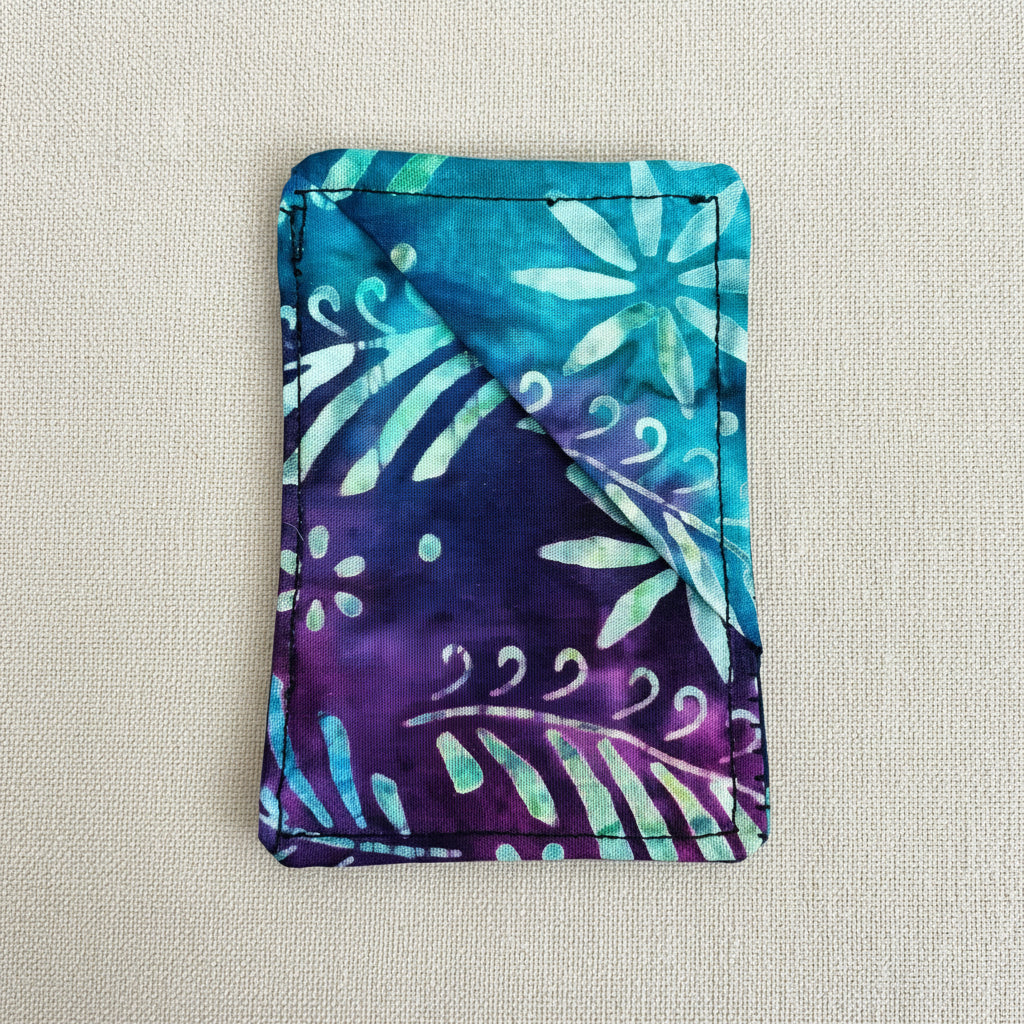 Colourful fabric corner bookmark with floral batik pattern in blue, purple and white. Rectangle shaped 
