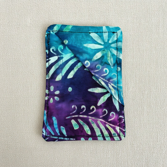 Colourful fabric corner bookmark with floral batik pattern in blue, purple and white. Rectangle shaped 