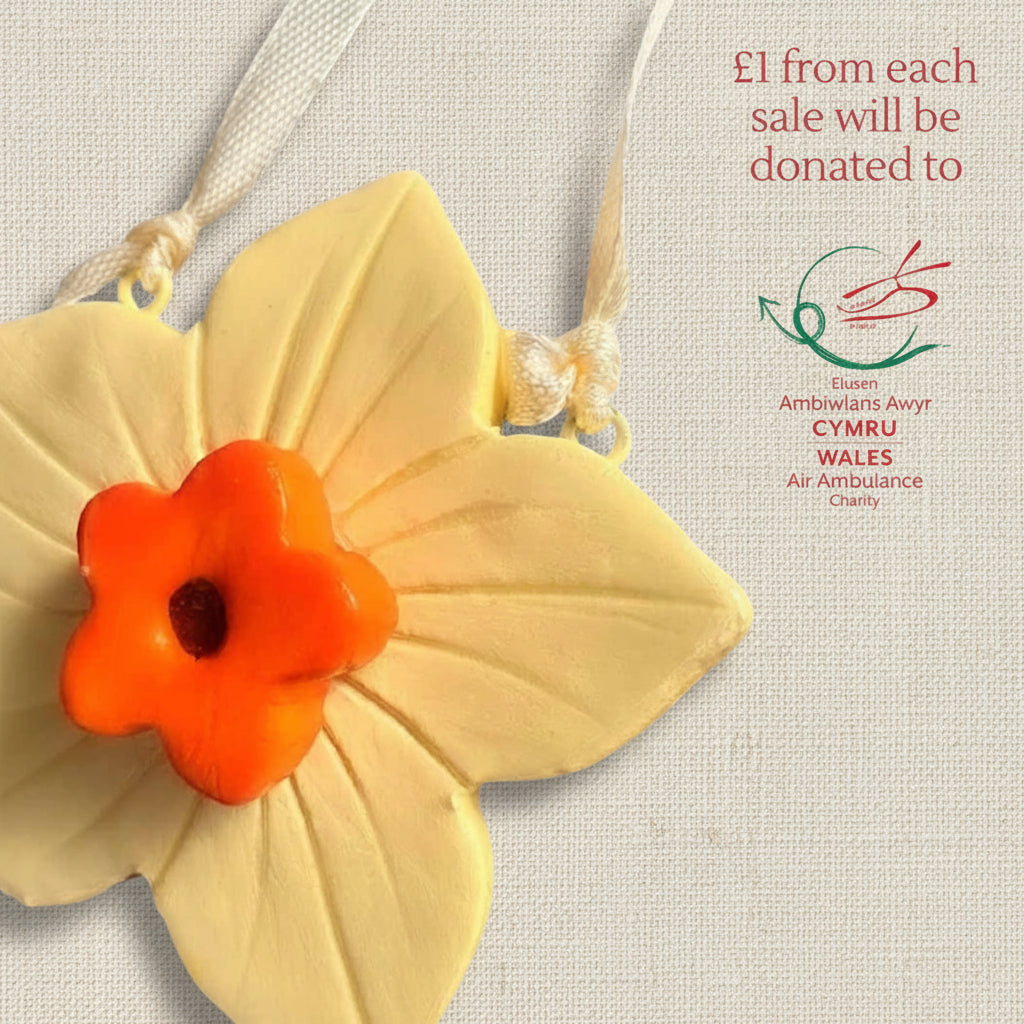 Clay yellow and orange daffodil ornament with ribbon to hang