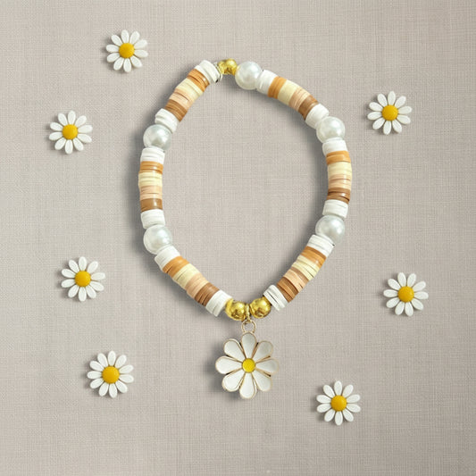 Natural colour flat beads bracelet with metal daisy charm, on linen background 