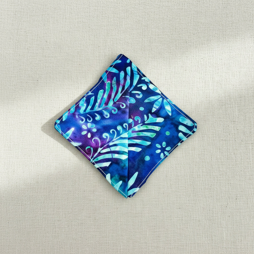 Blue and purple patterned fabric square corner bookmark on a neutral background, showing back of the bookmark