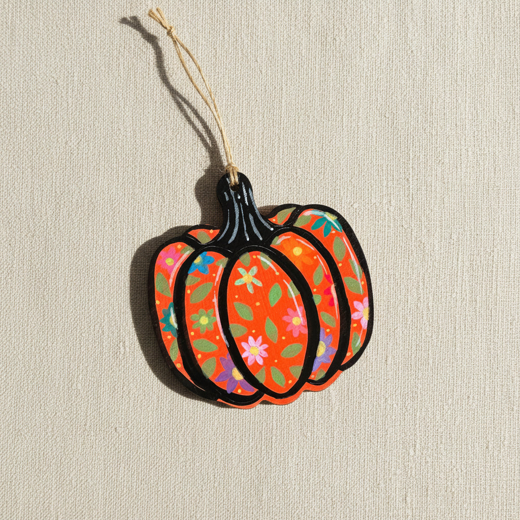 Decorative wooden pumpkin ornament with floral patterns