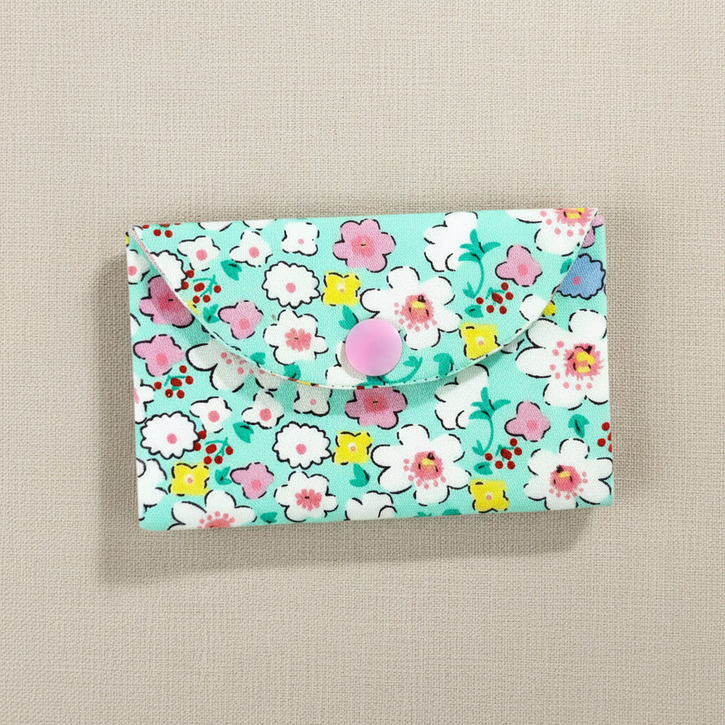 Floral patterned card wallet  on a natural linen background