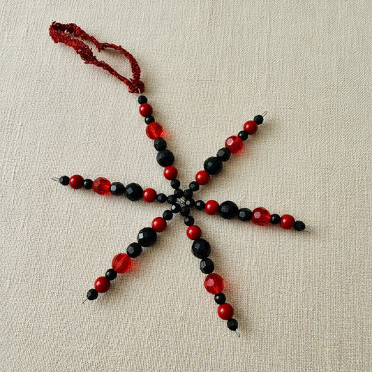 Red and black beaded snowflake decoration with red ribbon 