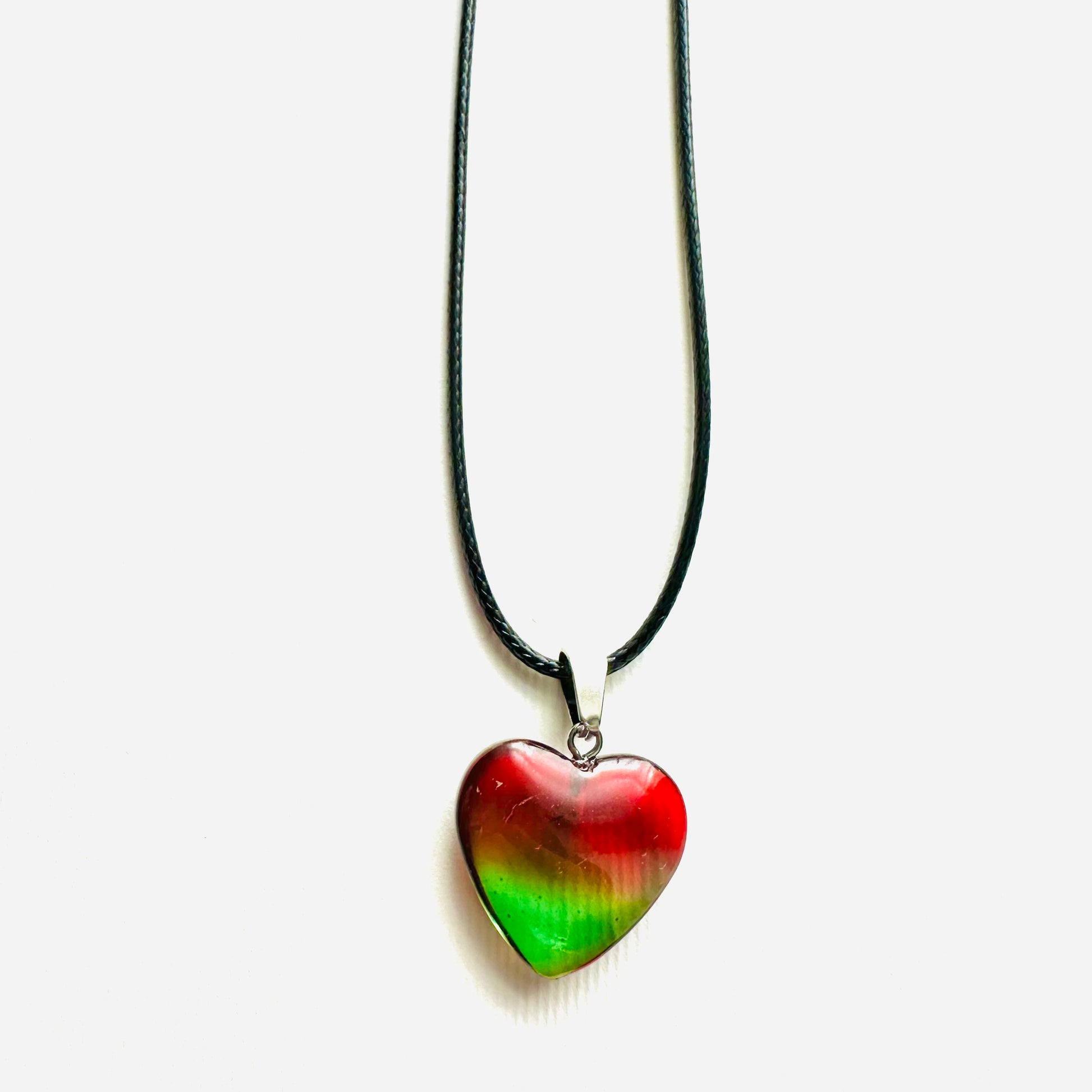 Heart-shaped pendant necklace with a red and green colour pattern on a white background