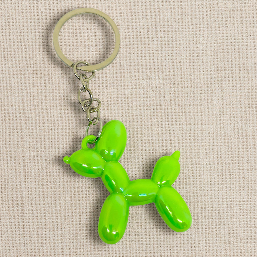 Green balloon dog keychain on a light background