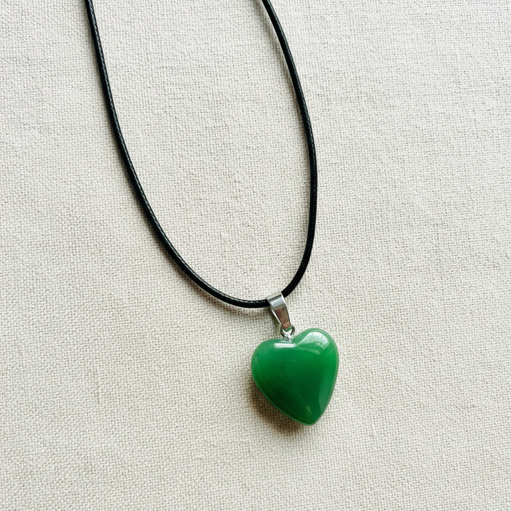 Green heart-shaped pendant on a black cord