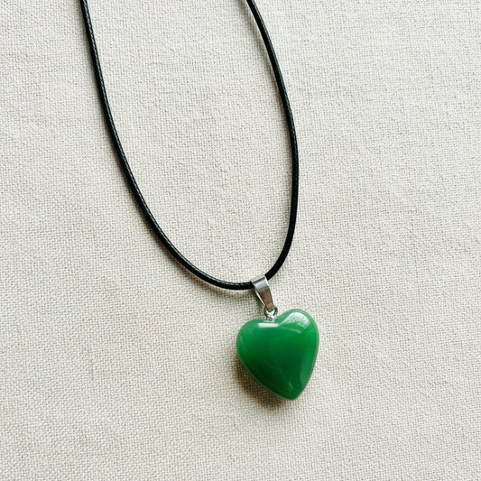 Green heart-shaped pendant on a black cord