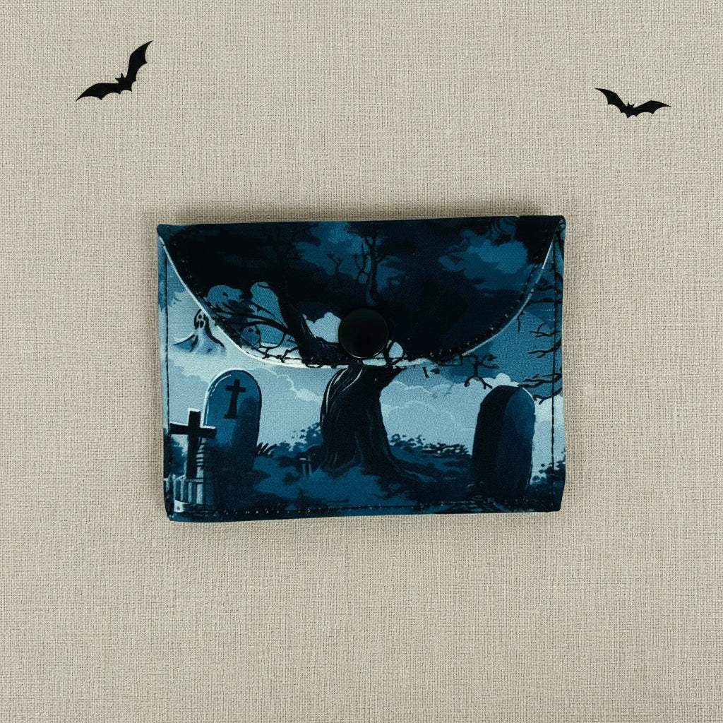 Card wallet with a design of a silhouette of a a tree in a cemetery at night.