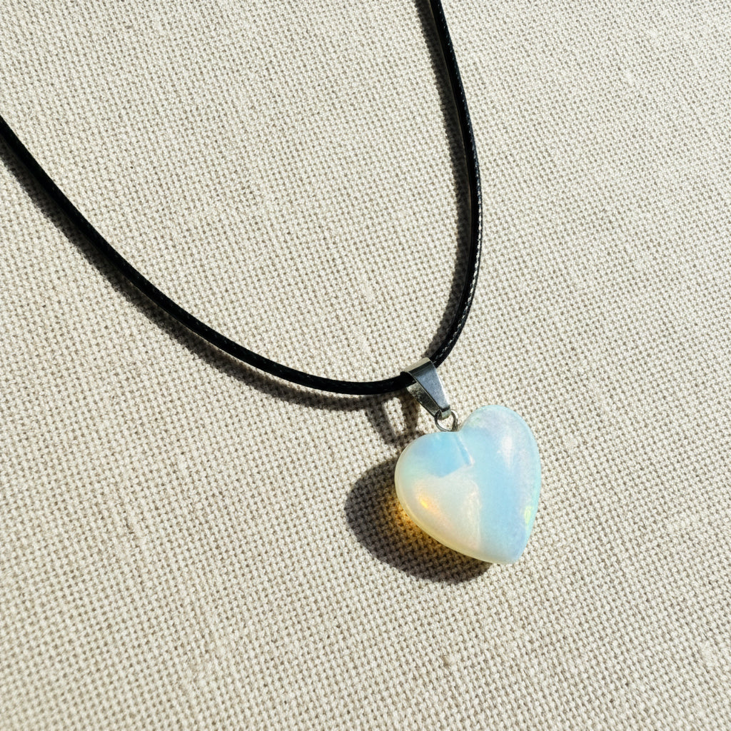 Heart-shaped opal pendant on a black cord