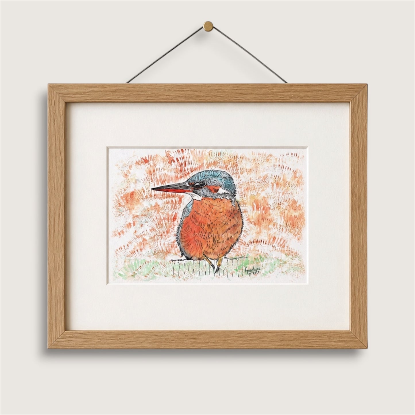 Framed artwork of a British kingfisher bird on a white wall