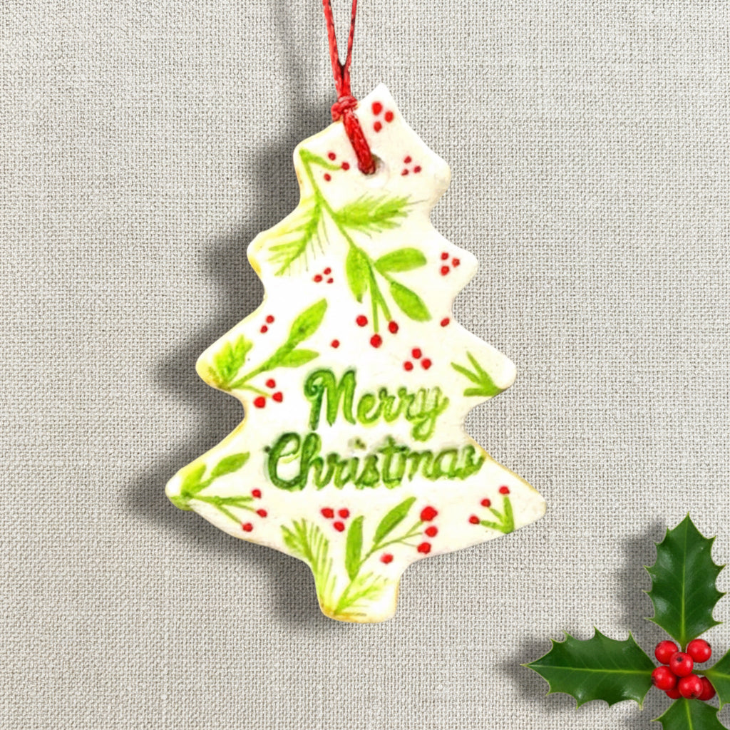 Christmas tree-shaped ornament with 'Merry Christmas' text on a light background