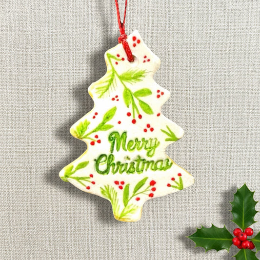 Christmas tree-shaped ornament with 'Merry Christmas' text on a light background