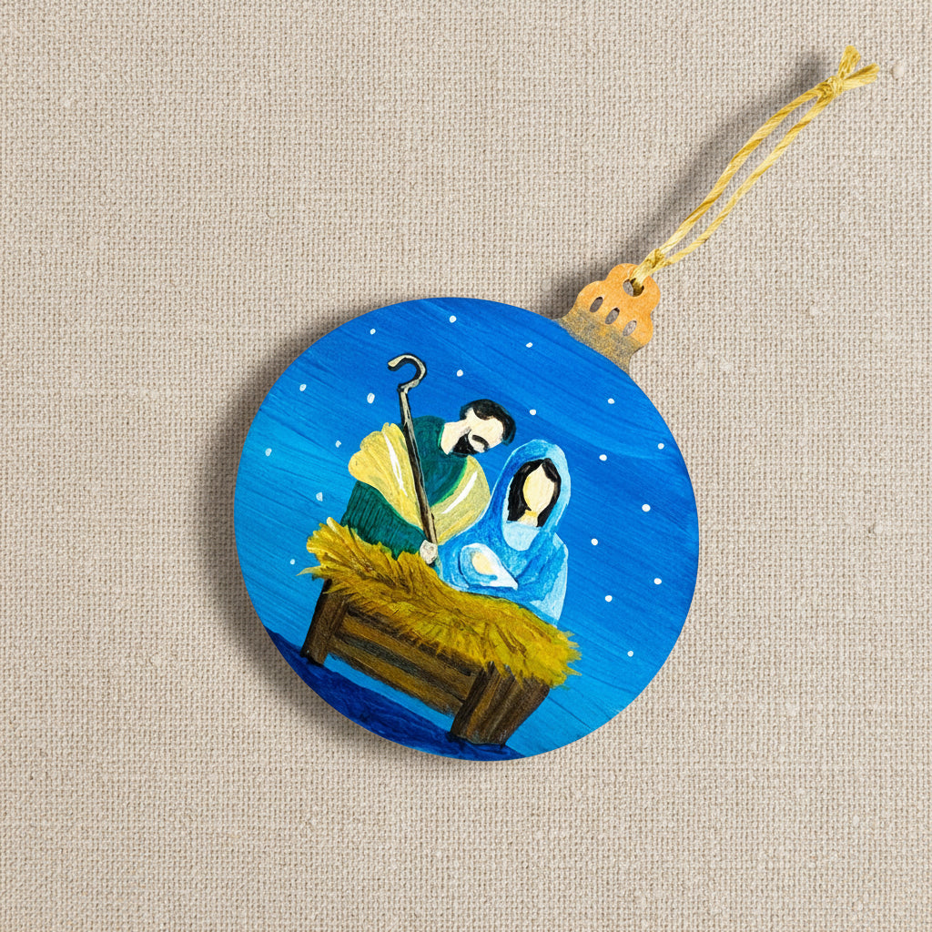 Decorative wooden ornament with a nativity scene on a blue background