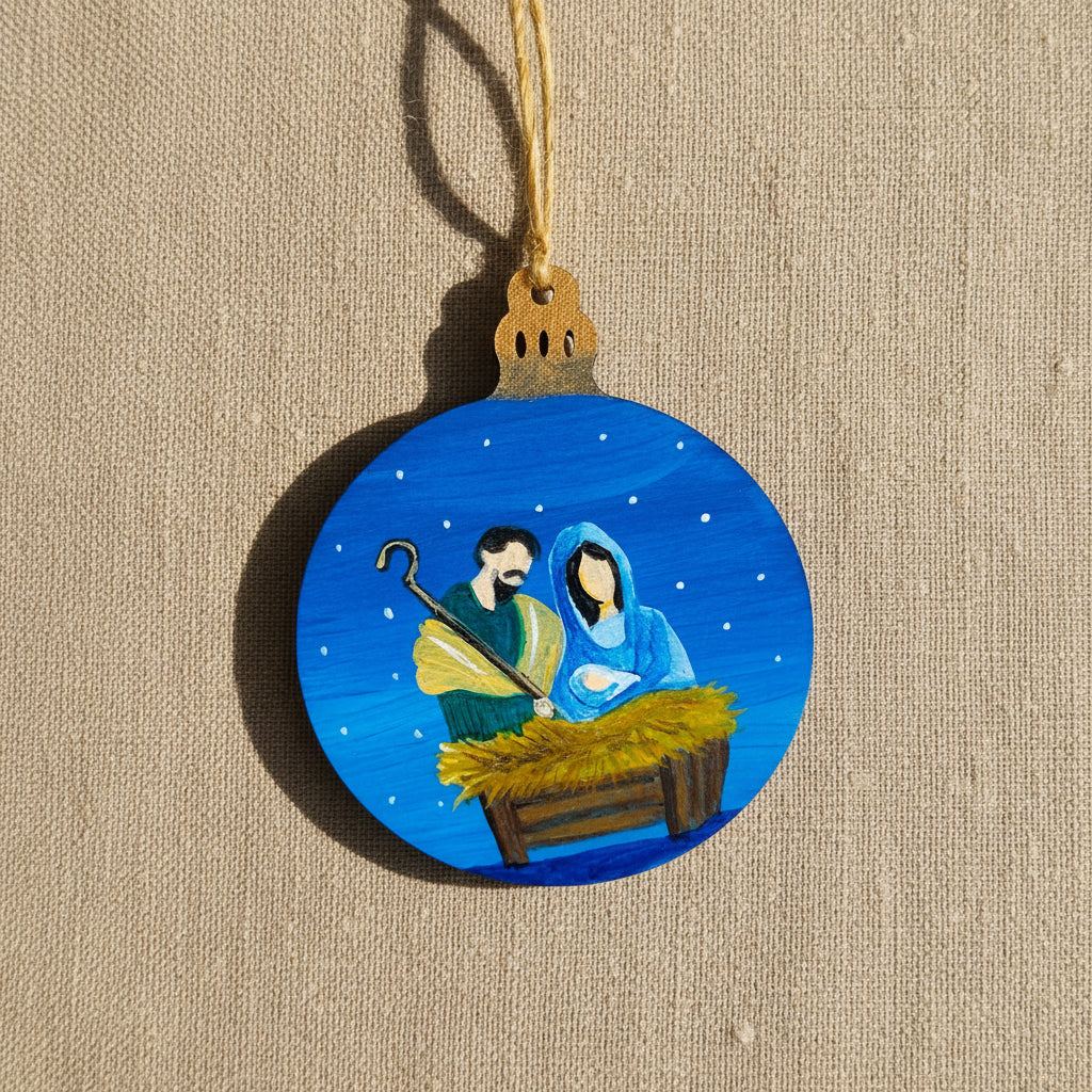 Decorative wooden Christmas ornament with a nativity scene on a blue background