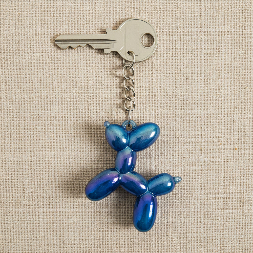 Blue balloon dog keychain on a light background