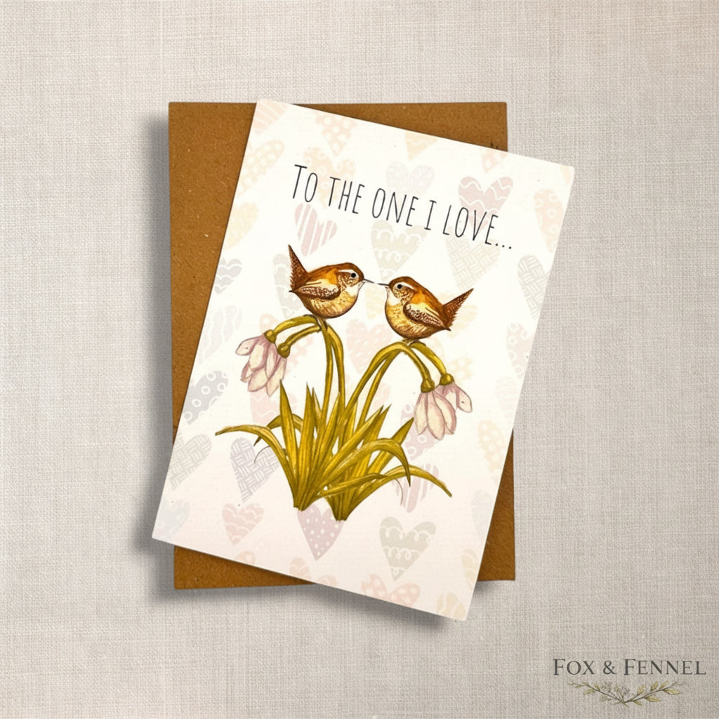 Greeting card for partner “one I love” with two British wren birds, faint heart background and snowdrop flowers, featuring the brand 'FOX & FENNEL'.