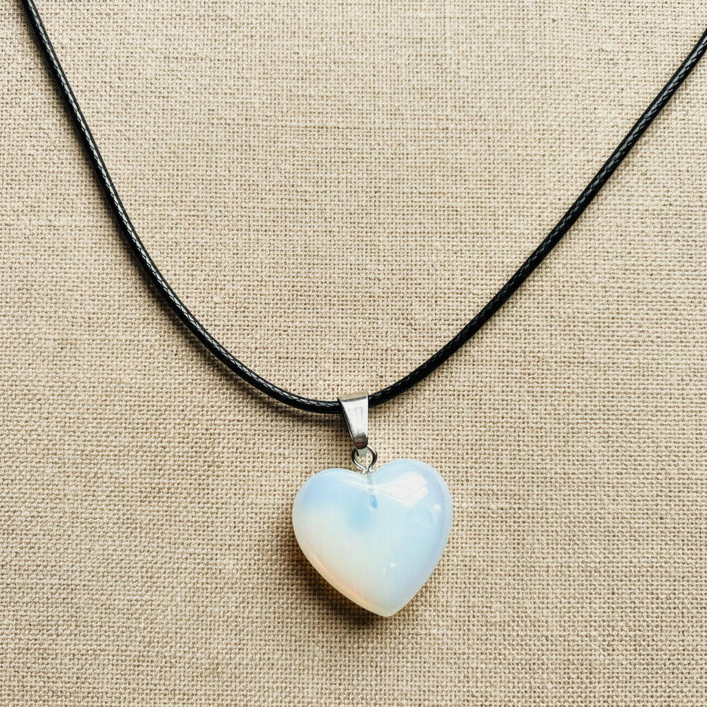 Heart-shaped opal pendant on a black cord