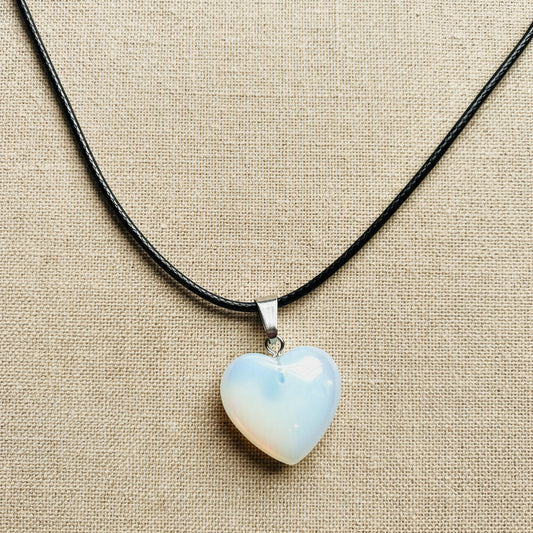 Heart-shaped opal pendant on a black cord