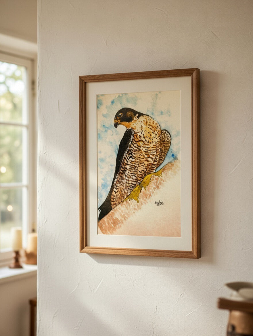 Framed artwork of a bird on a wall in a room with a window.