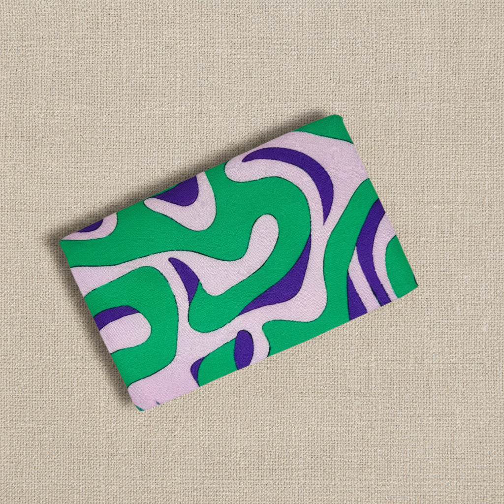 Back of card wallet with green and purple abstract pattern