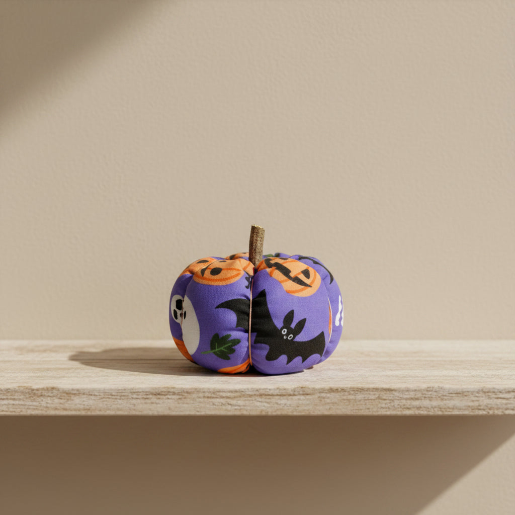 Halloween-themed fabric pumpkin with pumpkins and bats on a purple background