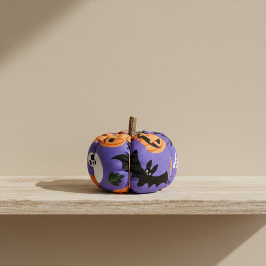Halloween-themed fabric pumpkin with pumpkins and bats on a purple background