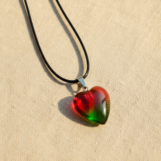 Heart-shaped pendant with a colourful red-green gradient on a light background