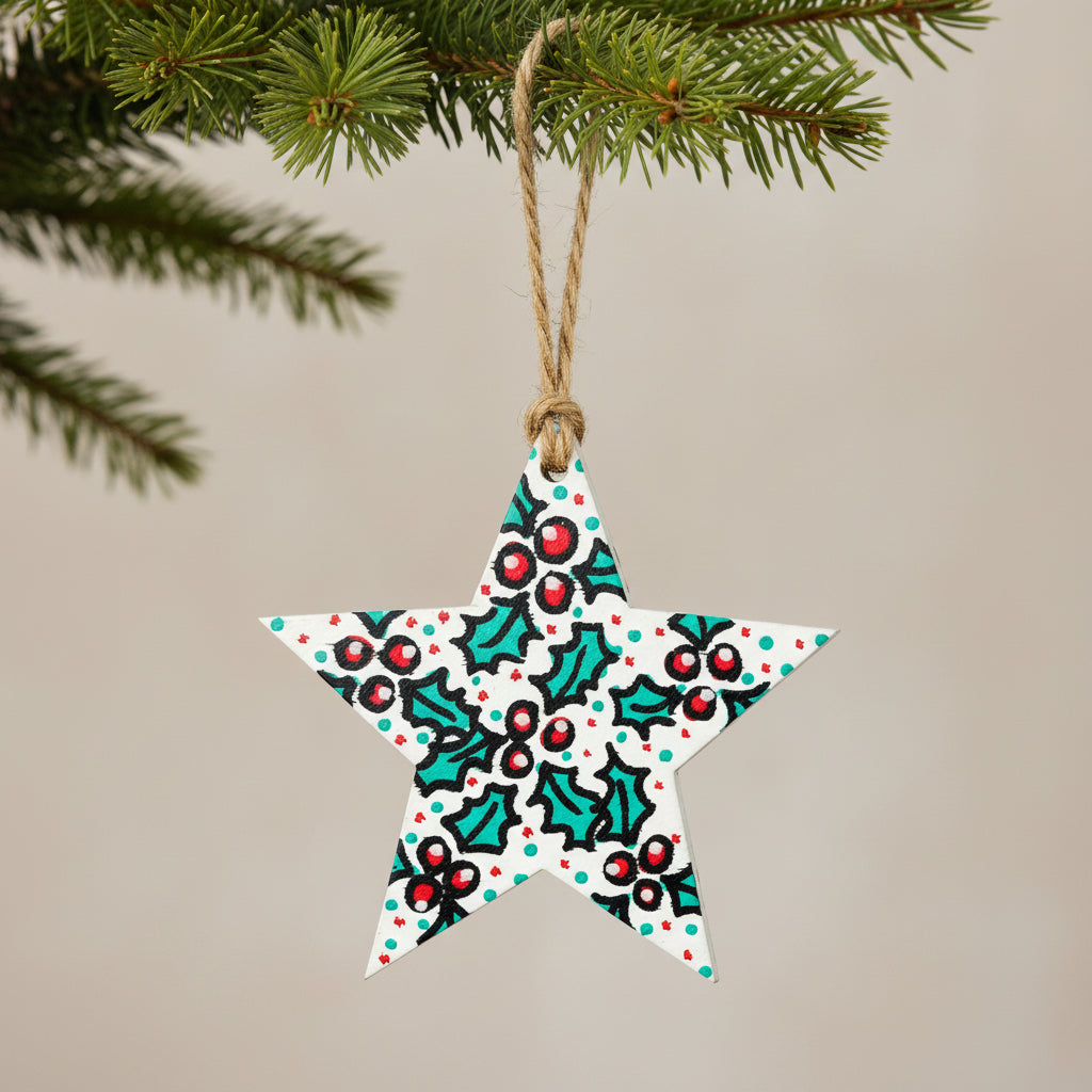Decorative star ornament with holly design on a white background