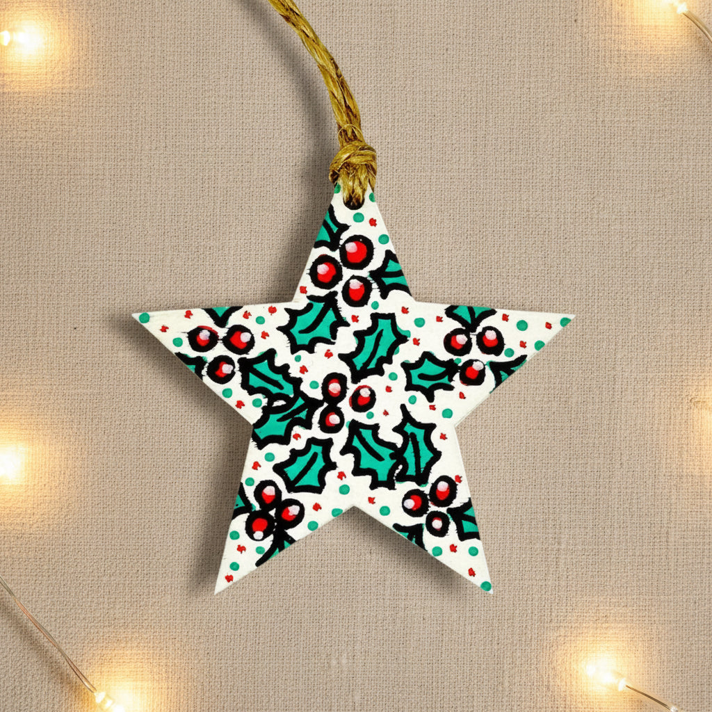 Star-shaped Christmas ornament with holly design on a light gray background