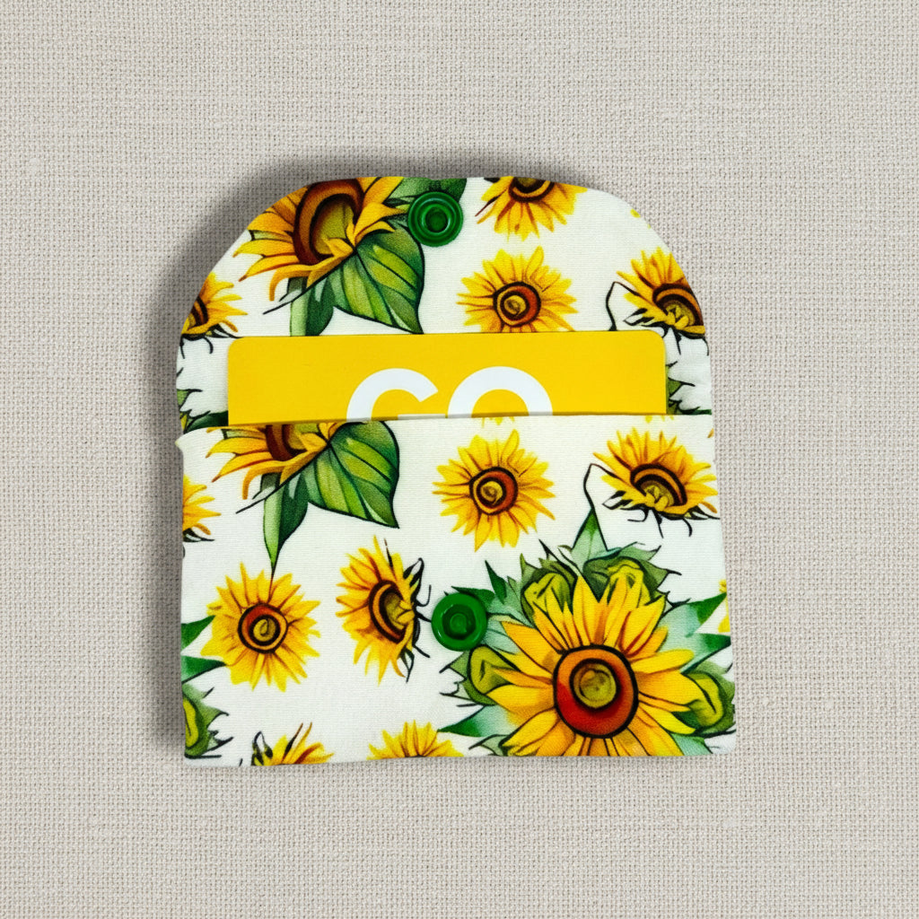 Cardholder with sunflower pattern on a white background, card wallet is open showing a store card inside 