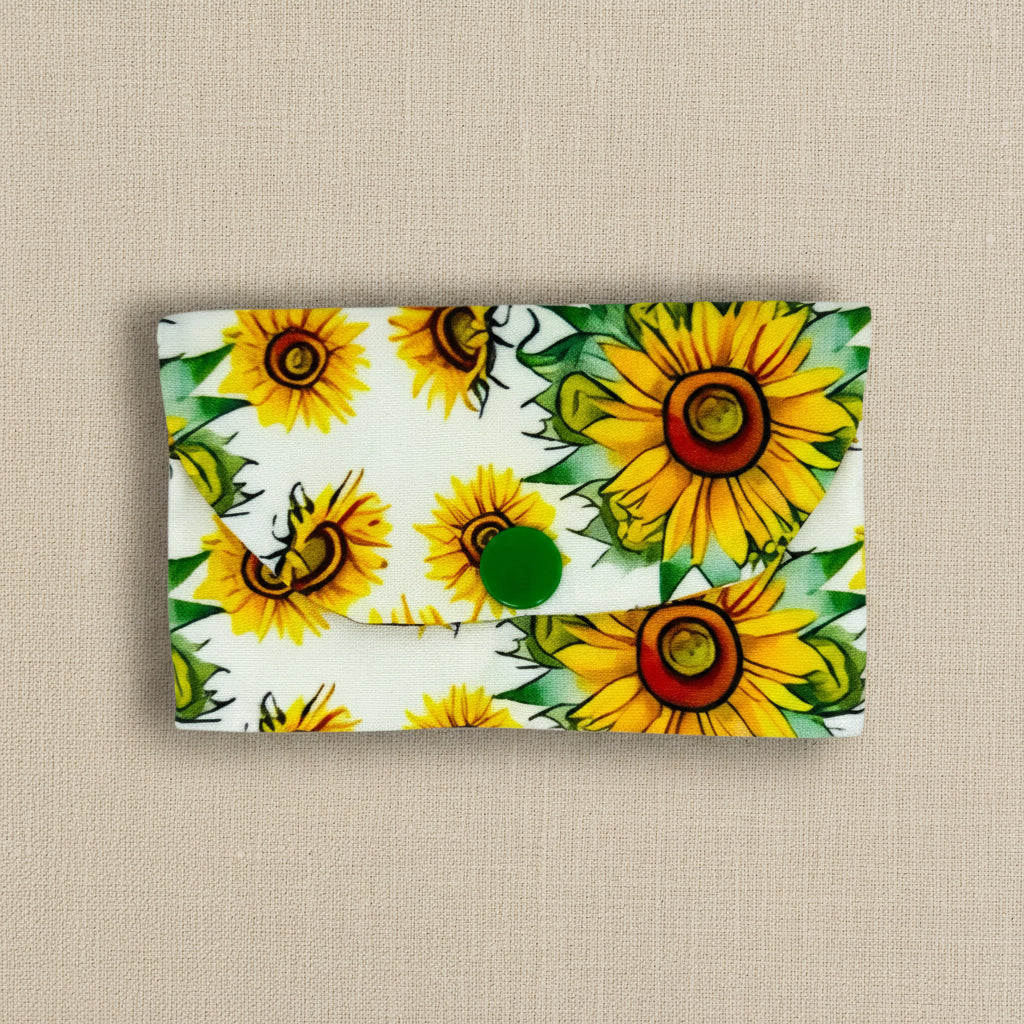 Card wallet with sunflower themed fabric on a white background 