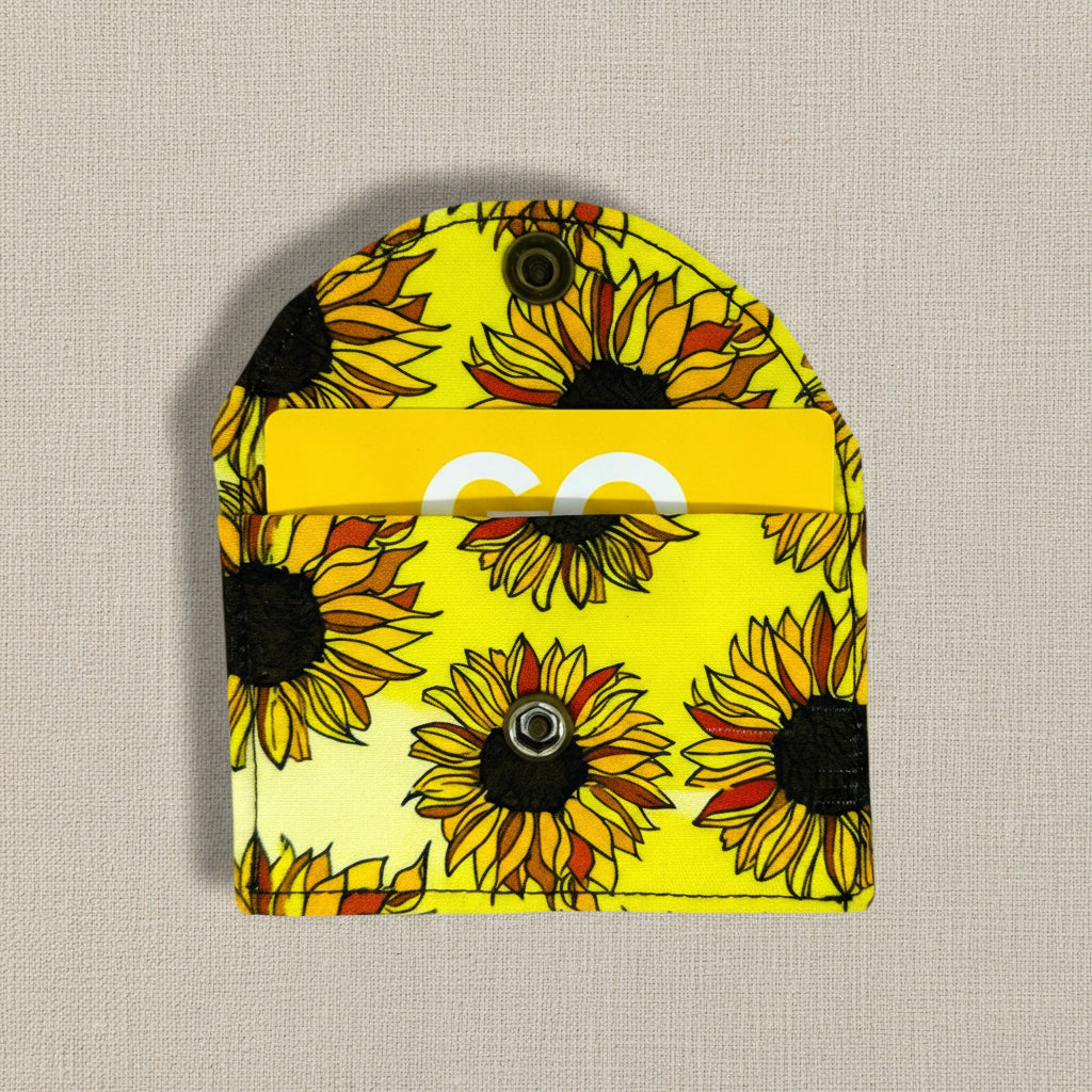 Yellow fabric background with sunflower designs- card wallet is shown open with a store card inside 
