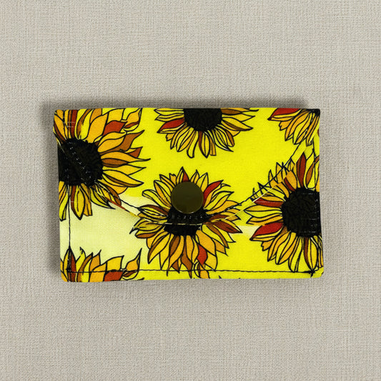 Card wallet with yellow background and sunflower designs 