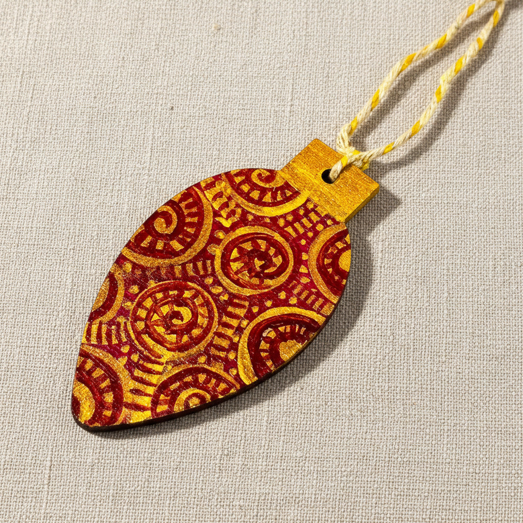 Decorative wooden Christmas tree ornament with red and gold pattern on a neutral background