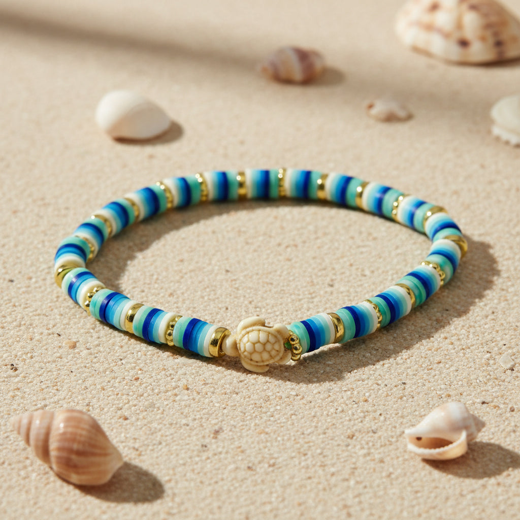 Striped bracelet with blue, white and gold colours and turtle charm
