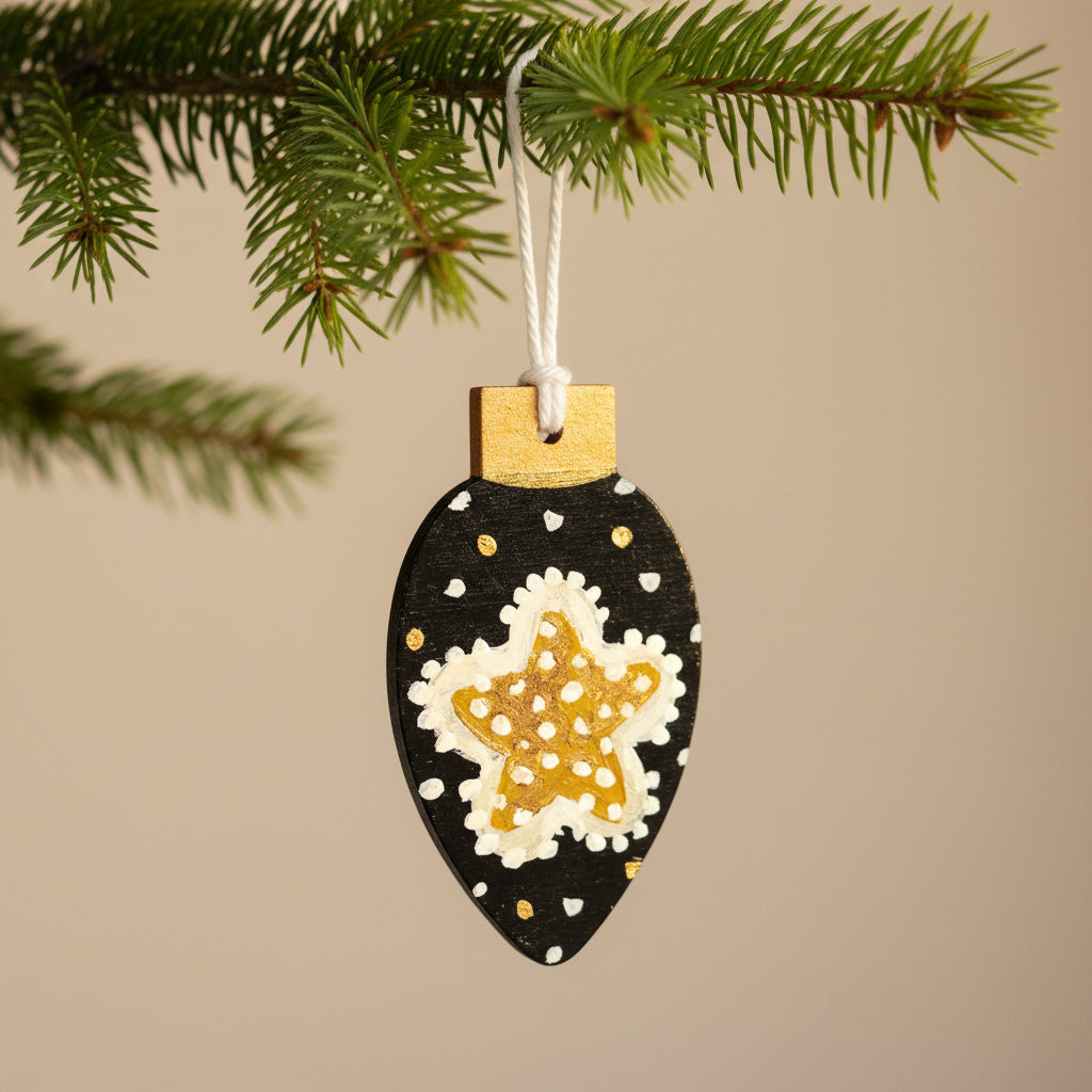 Decorative ornament with a starfish design on a black background, hanging against a neutral background.
