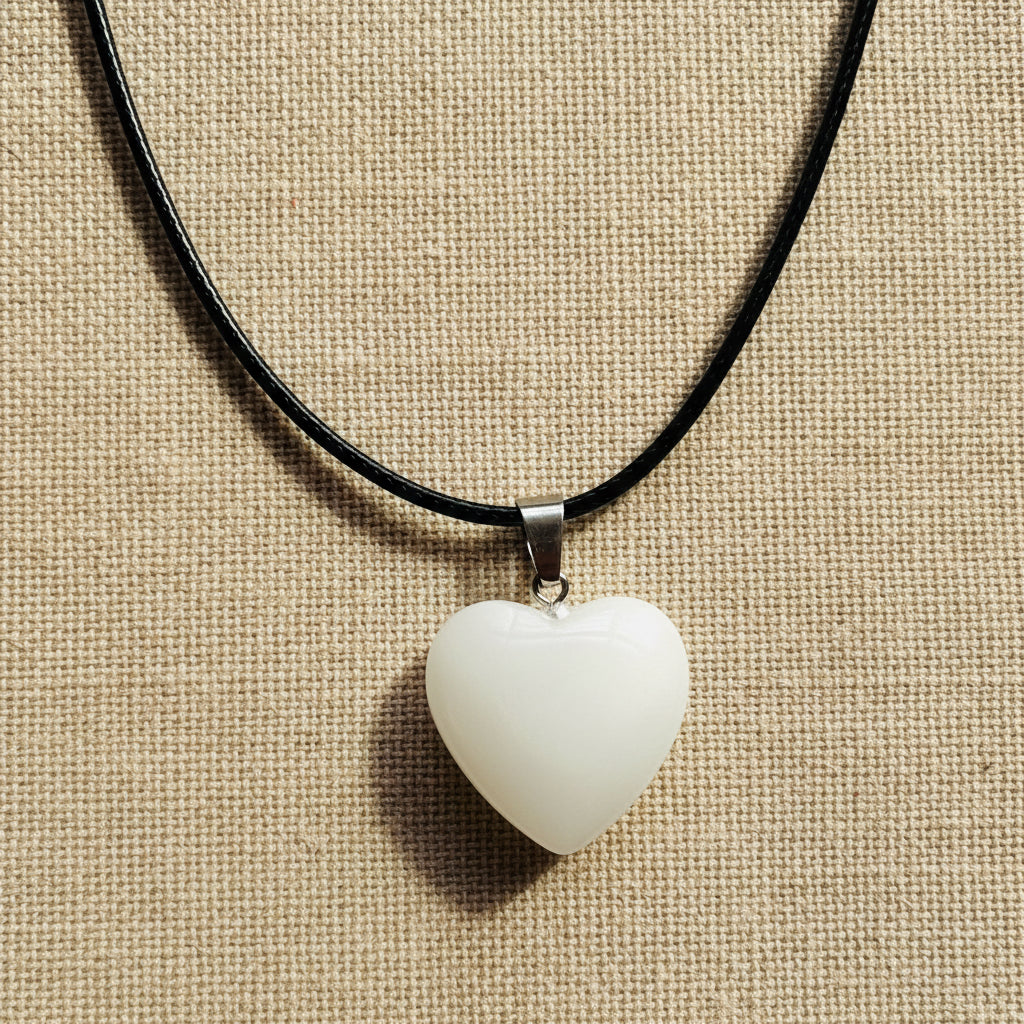 White Heart-shaped pendant on a black cord 