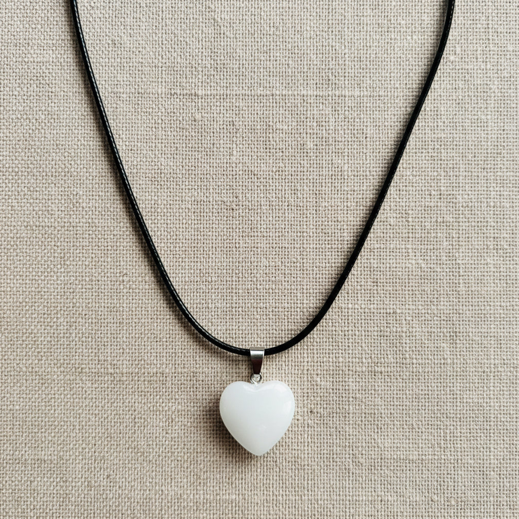 White Heart-shaped pendant on a black cord